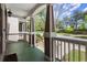 Inviting front porch with classic columns, painted floor, and a glimpse of the neighborhood at 1744 Habershal Nw Rd, Atlanta, GA 30318