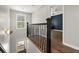 Well-lit hallway with a modern light fixture, hardwood floors, and an inviting view into another room at 1744 Habershal Nw Rd, Atlanta, GA 30318