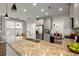 Open kitchen with granite countertops, stainless steel appliances, and a view into the dining area at 1744 Habershal Nw Rd, Atlanta, GA 30318