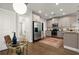 Well-lit kitchen featuring stainless steel appliances, ample cabinetry, and hardwood flooring at 1744 Habershal Nw Rd, Atlanta, GA 30318