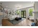 Bright and open living room with built-in shelving, hardwood floors, and access to a deck at 1744 Habershal Nw Rd, Atlanta, GA 30318