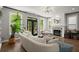 Bright living room features a modern fireplace, plush seating, and lots of natural light through the black-framed doors and windows at 1744 Habershal Nw Rd, Atlanta, GA 30318