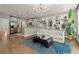 Open-concept living space with stainless appliances, breakfast bar, a cozy sofa, and stylish built in shelving at 1744 Habershal Nw Rd, Atlanta, GA 30318
