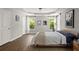 Spacious main bedroom with tray ceiling, hardwood floors, natural light, and neutral decor creating a serene retreat at 1744 Habershal Nw Rd, Atlanta, GA 30318