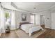 Bright main bedroom with tray ceiling, hardwood floors, ample natural light, and neutral decor creating a serene retreat at 1744 Habershal Nw Rd, Atlanta, GA 30318