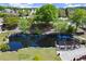 Scenic aerial view of a community pond surrounded by trees, benches, and walking paths at 1744 Habershal Nw Rd, Atlanta, GA 30318