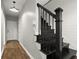 Staircase with a black railing and steps and a white shiplap wall running alongside the stairs at 1744 Habershal Nw Rd, Atlanta, GA 30318