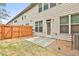 Cozy backyard featuring a small concrete patio and a wood fence, perfect for outdoor relaxation at 5661 Radford Loop, Fairburn, GA 30213