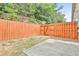 Fenced backyard with a small concrete patio and a gate at 5661 Radford Loop, Fairburn, GA 30213