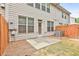 View of the backyard featuring a small patio and a wood fence that surrounds the lawn at 5661 Radford Loop, Fairburn, GA 30213