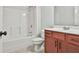 Full bathroom featuring tub shower, toilet, and vanity with cherry cabinet at 5661 Radford Loop, Fairburn, GA 30213