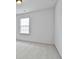 Bright, carpeted bedroom featuring a window that brings in natural light at 5661 Radford Loop, Fairburn, GA 30213