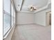 Bedroom featuring tray ceiling, ceiling fan, and large windows for natural light at 5661 Radford Loop, Fairburn, GA 30213
