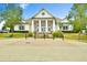 Elegant clubhouse with stately columns and manicured landscaping creates an inviting community gathering space at 5661 Radford Loop, Fairburn, GA 30213