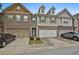 Charming townhome featuring a brick facade, a two-car garage, and a well-maintained lawn at 5661 Radford Loop, Fairburn, GA 30213