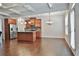 Open kitchen and dining area with stainless steel appliances and hardwood flooring at 5661 Radford Loop, Fairburn, GA 30213