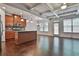 Open-concept living space featuring hardwood floors and a kitchen island at 5661 Radford Loop, Fairburn, GA 30213