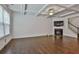 Bright living room with coffered ceiling, fireplace, hardwood floors, and staircase at 5661 Radford Loop, Fairburn, GA 30213