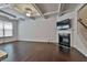 Spacious living room with hardwood floors, a fireplace, and a coffered ceiling at 5661 Radford Loop, Fairburn, GA 30213