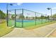 Community tennis courts with green surroundings, fenced and gated, with lampposts and paved pathway at 5661 Radford Loop, Fairburn, GA 30213