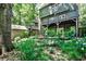 Spacious backyard with lush greenery, plants, and home exterior with balconies and outdoor seating at 1249 Francis Nw St, Atlanta, GA 30318