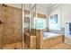 This bathroom features a tiled shower and a soaking tub under a window for natural light at 1249 Francis Nw St, Atlanta, GA 30318