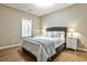 Cozy bedroom featuring hardwood floors, a comfortable bed, and two nightstands with lamps, and natural light from window at 1249 Francis Nw St, Atlanta, GA 30318