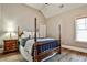 This bedroom offers a four-poster bed and beautiful hardwood floors at 1249 Francis Nw St, Atlanta, GA 30318