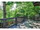 A wooden deck surrounded by tall trees and greenery at 1249 Francis Nw St, Atlanta, GA 30318