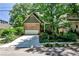 Charming home with a stone and siding exterior, lush landscaping, and a driveway leading to an attached garage at 1249 Francis Nw St, Atlanta, GA 30318