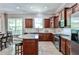 Open kitchen featuring wood cabinets, granite countertops, stainless appliances, and seamless integration with the dining area at 1249 Francis Nw St, Atlanta, GA 30318