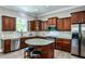 Well-appointed kitchen featuring stainless steel appliances, granite countertops, wood cabinets, and a kitchen island at 1249 Francis Nw St, Atlanta, GA 30318