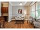 Elegant living room featuring hardwood floors, a neutral color scheme, and wainscoting detail throughout the room at 1249 Francis Nw St, Atlanta, GA 30318