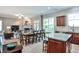 Open-concept living space featuring wood floors, a modern kitchen, a dining area, and a cozy living room with a fireplace at 1249 Francis Nw St, Atlanta, GA 30318