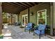 Outdoor patio features a seating area with comfortable chairs, adjacent to green home with bright window at 1249 Francis Nw St, Atlanta, GA 30318