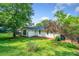 Charming backyard with green grass, mature trees, and landscaping, providing a peaceful and private outdoor space for relaxation at 4458 Trickum Ne Rd, Marietta, GA 30066