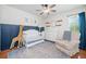 Comfortable Bedroom with chair, decor, crib, dresser, neutral colors, and a ceiling fan at 4458 Trickum Ne Rd, Marietta, GA 30066