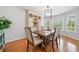 Bright dining room with a wooden table, six chairs, a hutch, and windows for natural light at 4458 Trickum Ne Rd, Marietta, GA 30066