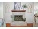Cozy brick fireplace with a wooden mantle and decorative accents at 4458 Trickum Ne Rd, Marietta, GA 30066