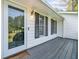Inviting front porch with a gray wood deck, a glass front door and house number 4458 at 4458 Trickum Ne Rd, Marietta, GA 30066