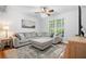Comfortable living room with a large sectional sofa, a ceiling fan, hardwood floors and bright natural light at 4458 Trickum Ne Rd, Marietta, GA 30066