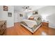 Bright main bedroom with hardwood floors, a ceiling fan, comfortable bed, and warm decor at 4458 Trickum Ne Rd, Marietta, GA 30066