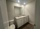 Modern bathroom featuring double sinks with a white cabinet and a large mirror at 75 Emerald Ln, Covington, GA 30014