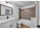 Well-lit bathroom with modern vanity, tiled shower, and coordinating fixtures at 923 Smith Sw St, Atlanta, GA 30310