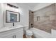 Bright bathroom featuring a combination bath shower, stylish tile and modern fixtures at 923 Smith Sw St, Atlanta, GA 30310