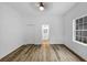 Bright bedroom featuring wood floors, ceiling fan, and window at 923 Smith Sw St, Atlanta, GA 30310