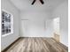 Bedroom with wood-look floors, closet, and a window providing natural light at 923 Smith Sw St, Atlanta, GA 30310