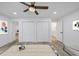 Bright bedroom featuring wood floors, ceiling fan, and ensuite bathroom and closet at 923 Smith Sw St, Atlanta, GA 30310