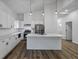Bright kitchen featuring white cabinets, stainless steel appliances, and a large island at 923 Smith Sw St, Atlanta, GA 30310