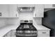 Kitchen featuring stainless steel stove and hood, and white countertops at 923 Smith Sw St, Atlanta, GA 30310